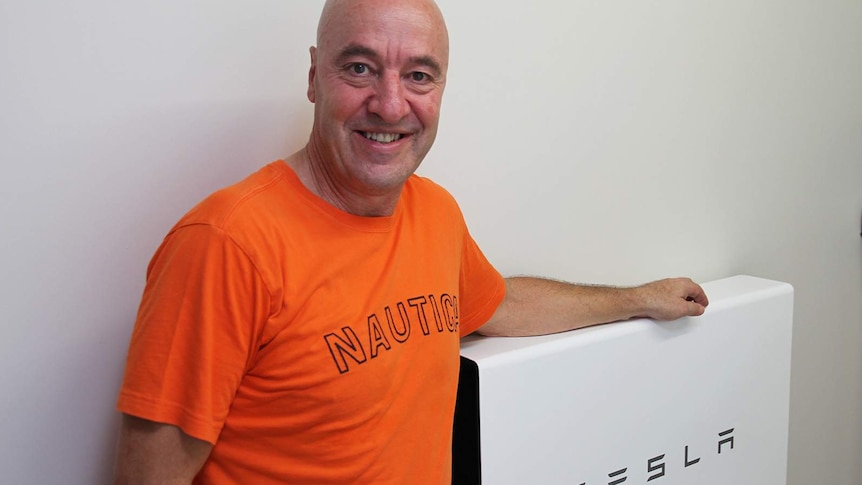 Townsville accountant Mark Hiscox with his $12,000 Tesla battery