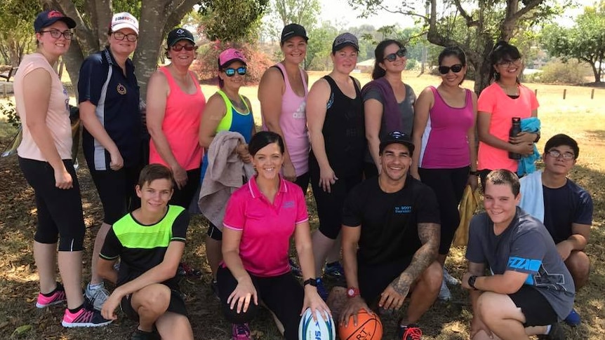 Youth worker Lisa Limpus, personal trainer Mitch Terrick, and a group of exercise workshop attendees in Biloela.