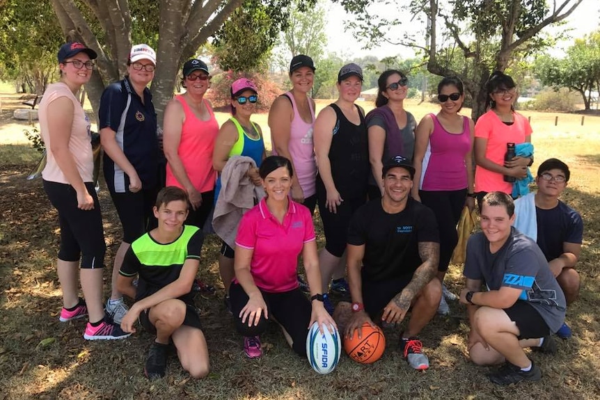 Youth worker Lisa Limpus, personal trainer Mitch Terrick, and a group of exercise workshop attendees in Biloela.