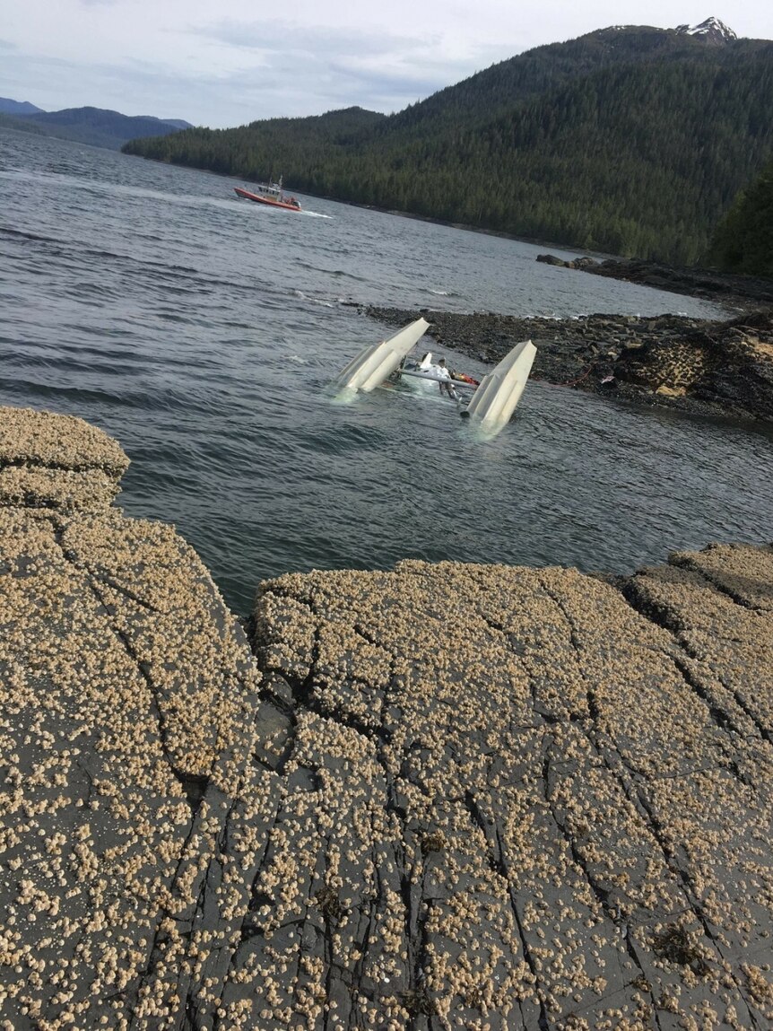 A sea plane's landing gear is seen upside down submerged in water