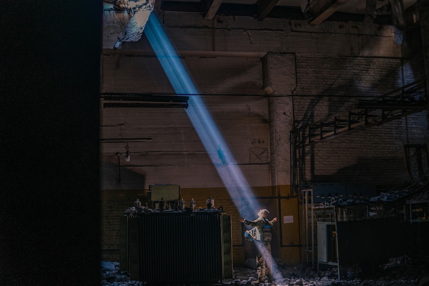 Man bathes in ray of sunlight.