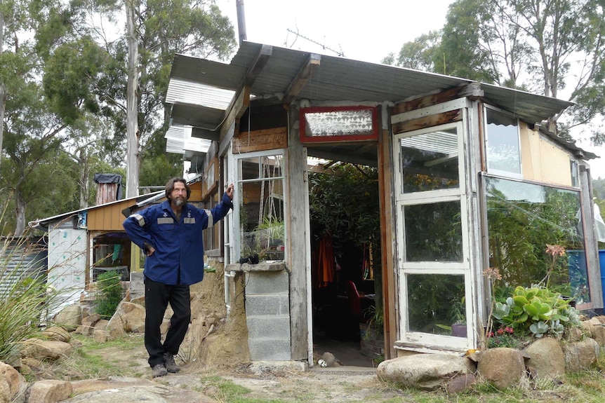 Rob standing outside his shack.