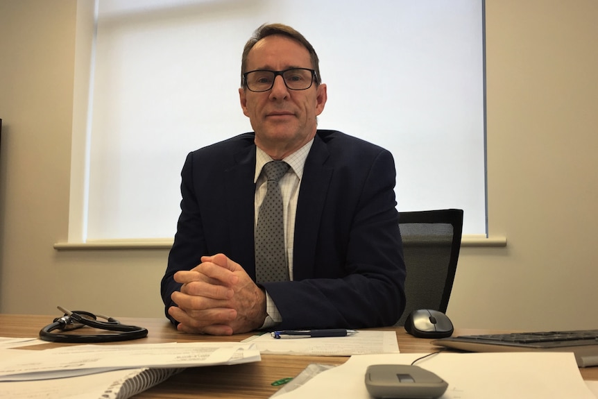 Cardiologist Dr Geoffrey Evans sitting at his desk.