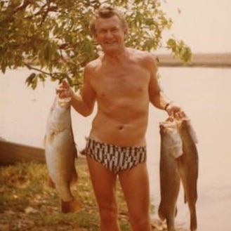 Bob Hawke with three barramundi.