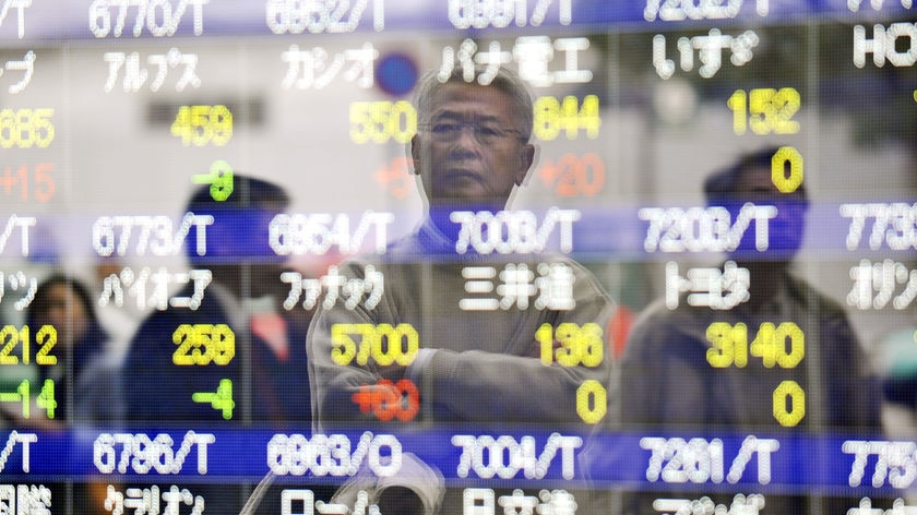 A man looks at quotation board flashing share princes of the Tokyo Stock Exchange.