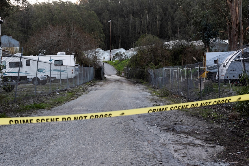 A driveway leading to a farm is taped off, the day after a mass shooting.