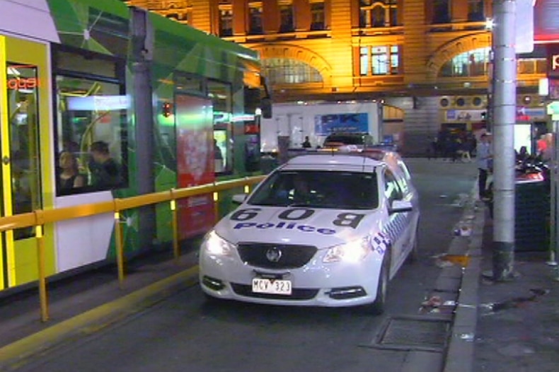 A Victoria Police car patrols Melbourne's CBD