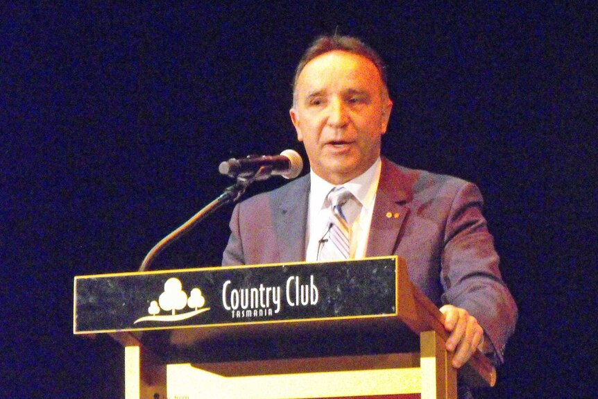 Andrew Nikolic, Bass MP at podium June 16 2016