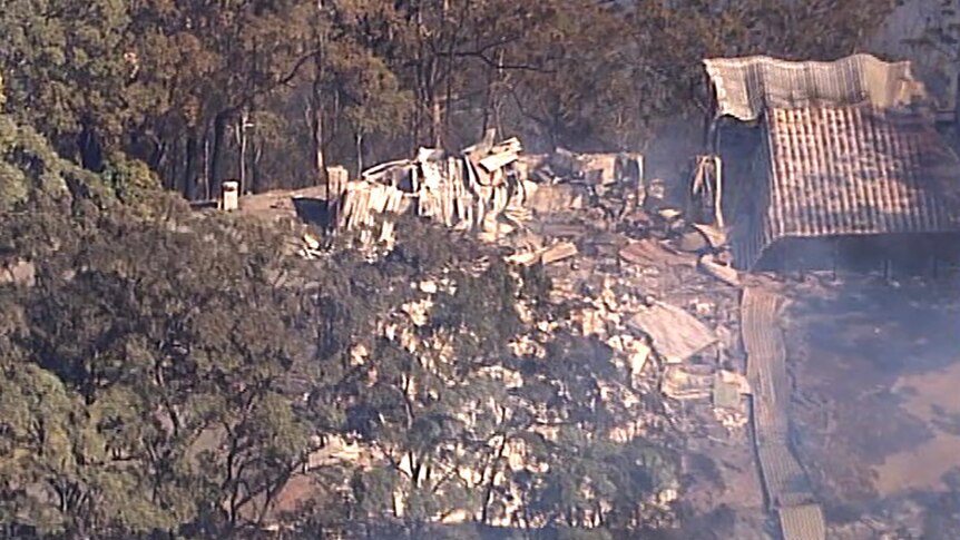 The burnt remains of a mountain lodge after a bushfire