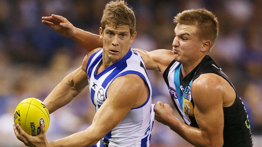 North Melbourne's Nick Dal Santo is tackled by Port Adelaide's Ollie Wines in round three, 2014.