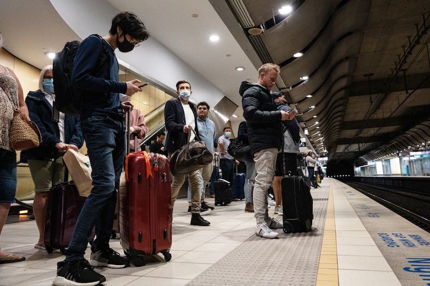 People standing on a platform waiting for a train