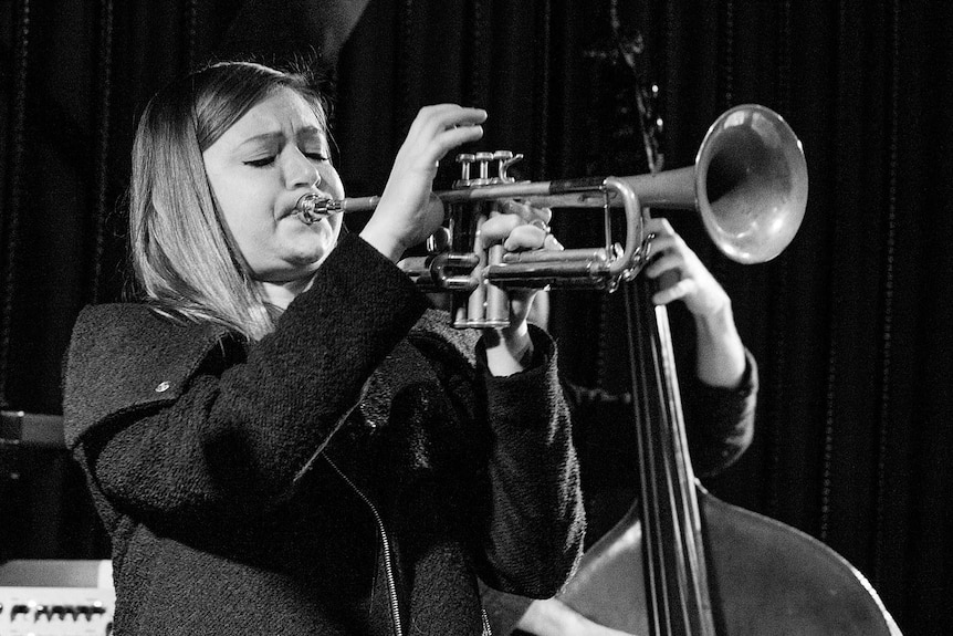 Black and white image of Melbourne-based jazz trumpet player Audrey Powne performing.