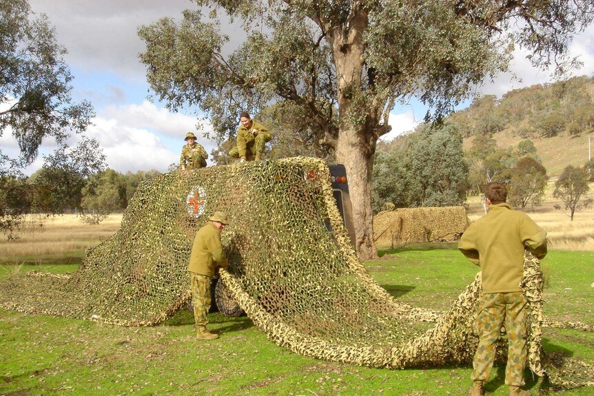 Men and women in a training exercise in the bush.