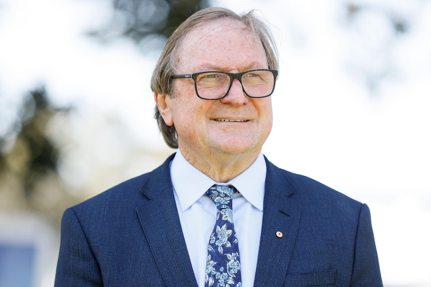 A photo of Kevin Sheedy standing at Royal Randwick Racecourse in 2019.