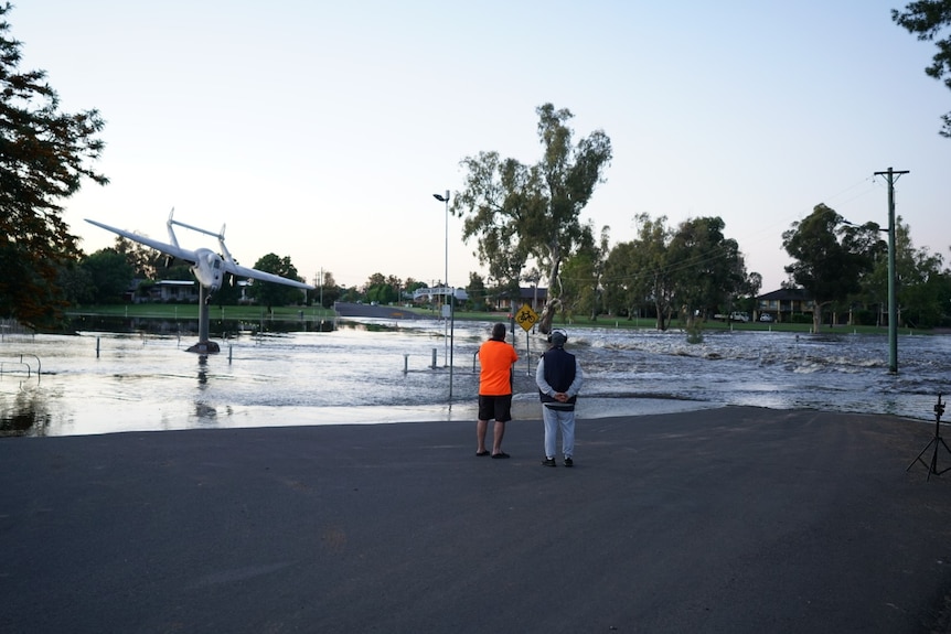 Forbes residents watching a lagoon filling with flood water at sunrise