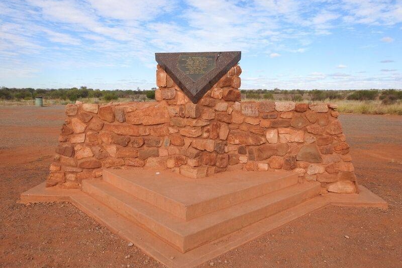 A stone monument on the side of the Stuart Highway in Central Australia.