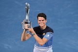 Milos Raonic holds aloft the Brisbane international trophy