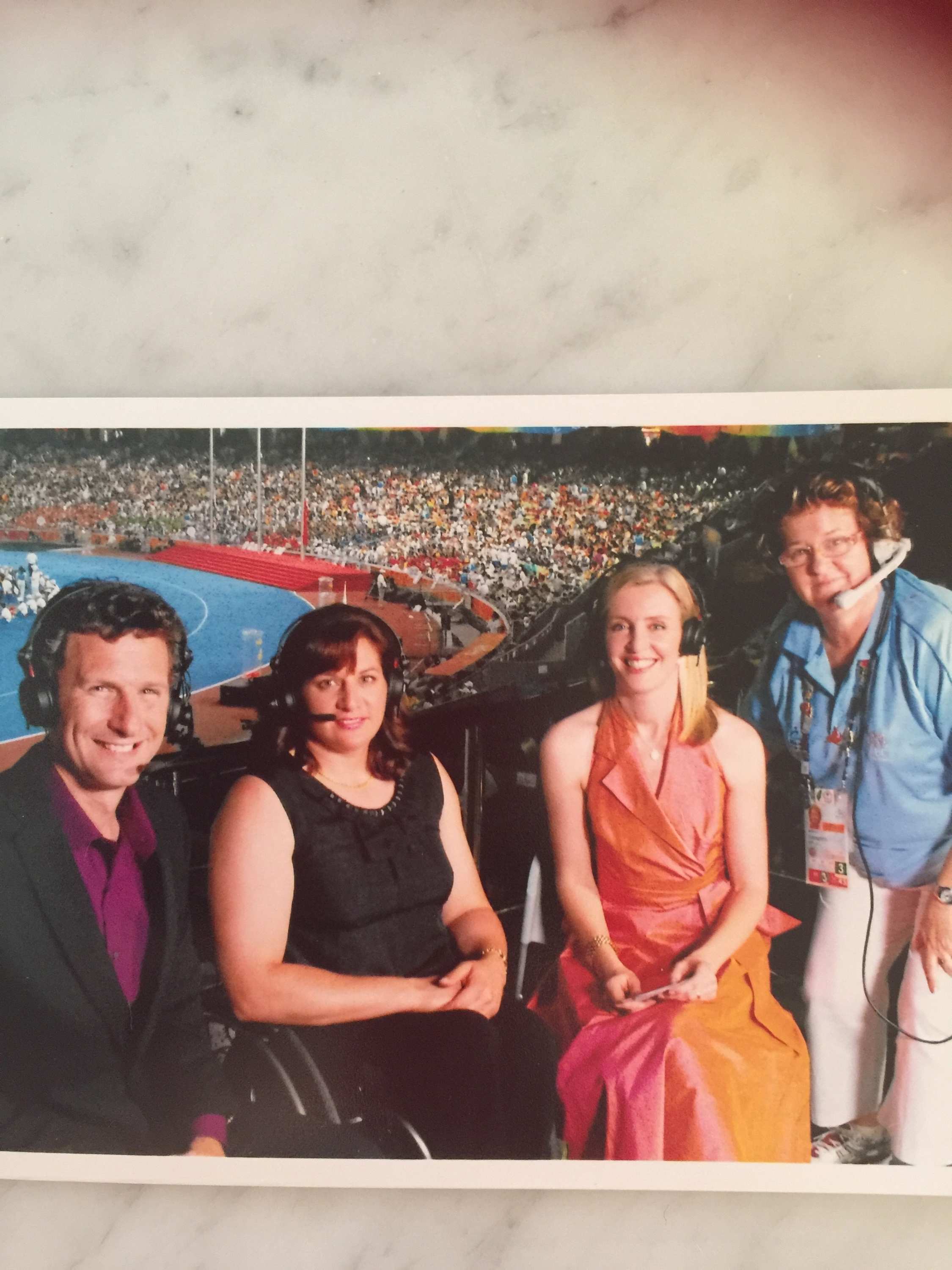 Tighe in broadcasting box alongside woman in a wheelchair, floor manager and a man all wearing headphones.