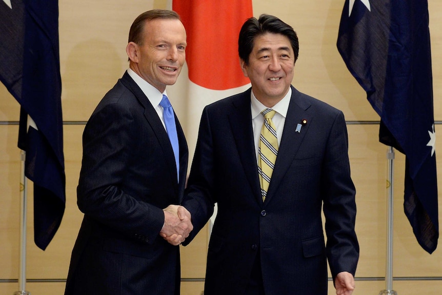 Tony Abbott and Shinzo Abe shake hands