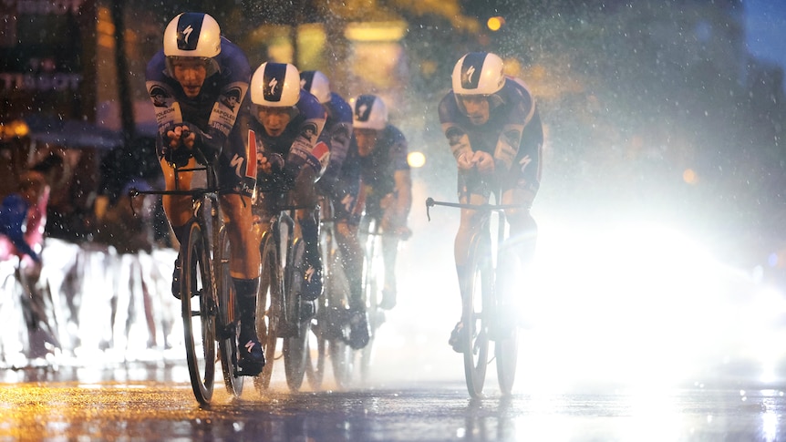 Soudal-Quickstep ride in the rain and dark at the 2023 Vuelta a España.