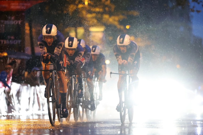 Soudal-Quickstep ride in the rain and dark at the 2023 Vuelta a España.