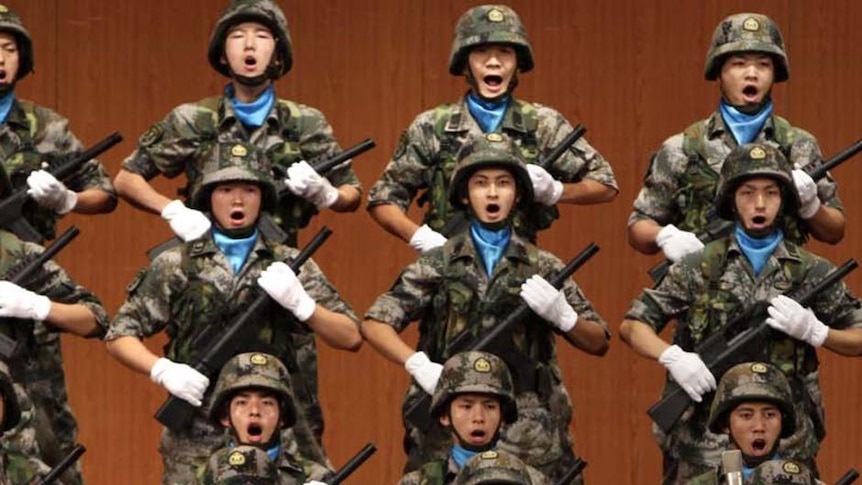 Soldiers hold toy guns