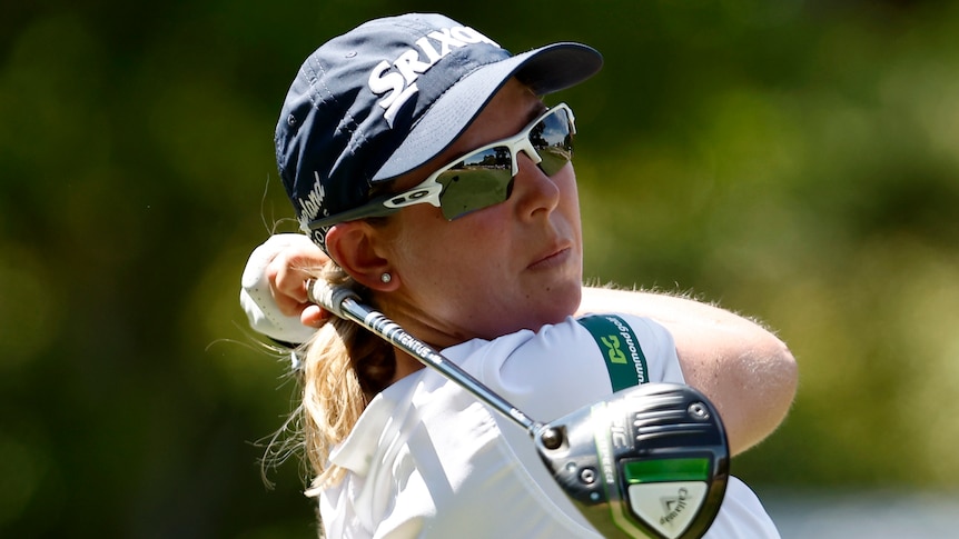 A South African female golfer hits a tee shot at the Australian Open.