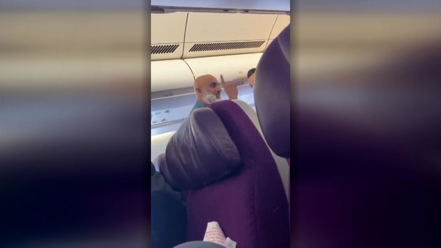 Passenger confronts cabin crew on board flight MH122