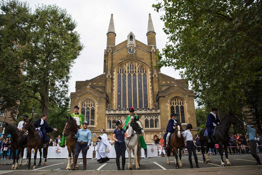 The Reverend Stephen Mason (third left) delivers a church service on horseback