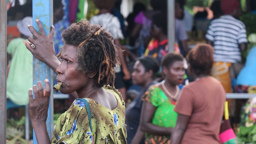 A woman chews betal nut at a market in Arawa, Bougainville.