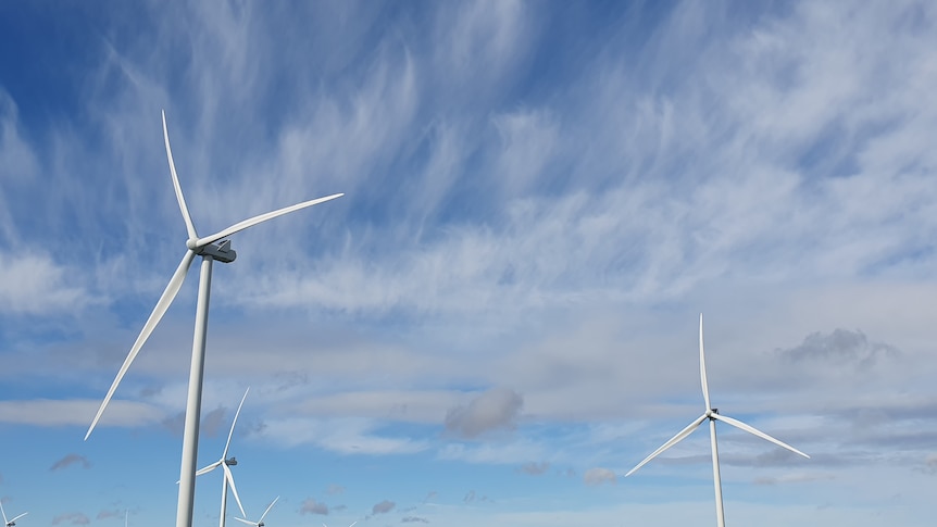 A blue and white sky and wind turbines