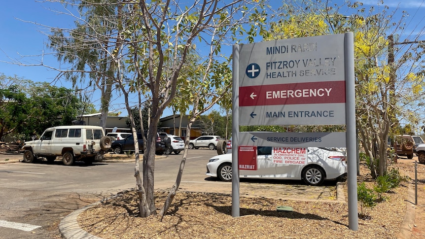 a hospital sign in front of a car park