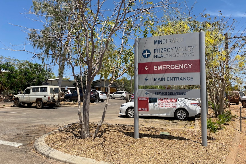 a hospital sign in front of a car park