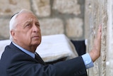 Israeli prime minister-elect Ariel Sharon places his hand on the Western Wall, in the Old City of Jerusalem.