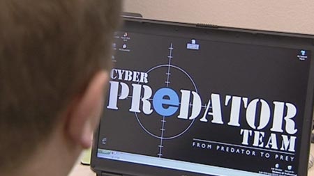 A police officer in front of a computer screen with information about a taskforce targeting cyber predators.
