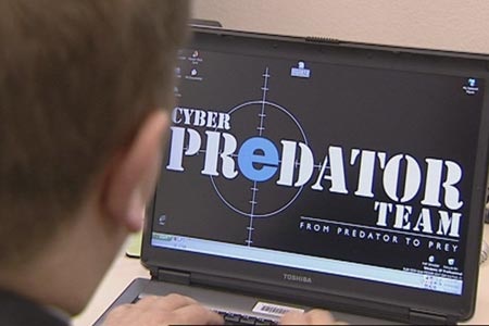 A police officer in front of a computer screen with information about a taskforce targeting cyber predators.