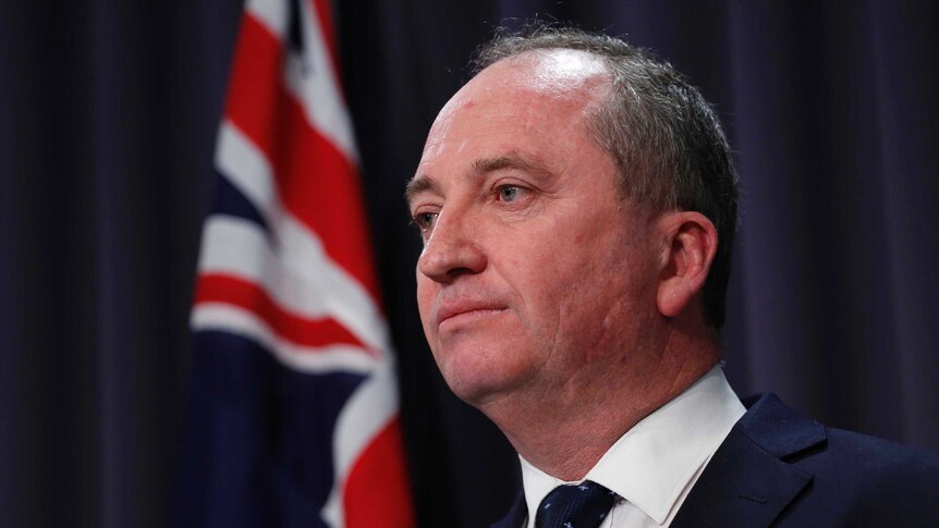 Barnaby Joyce's mouth is closed as he looks off camera during a press conference on July 26, 2017.