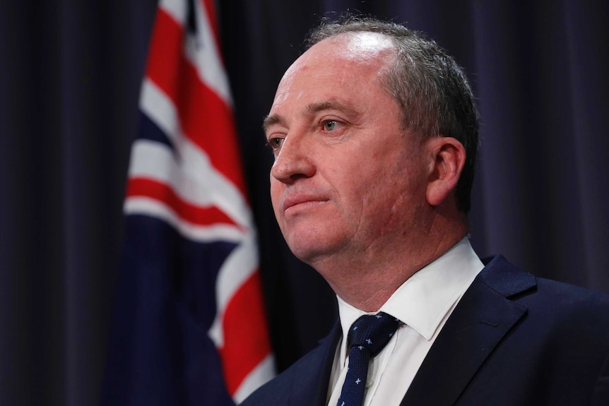 Barnaby Joyce's mouth is closed as he looks off camera during a press conference on July 26, 2017.