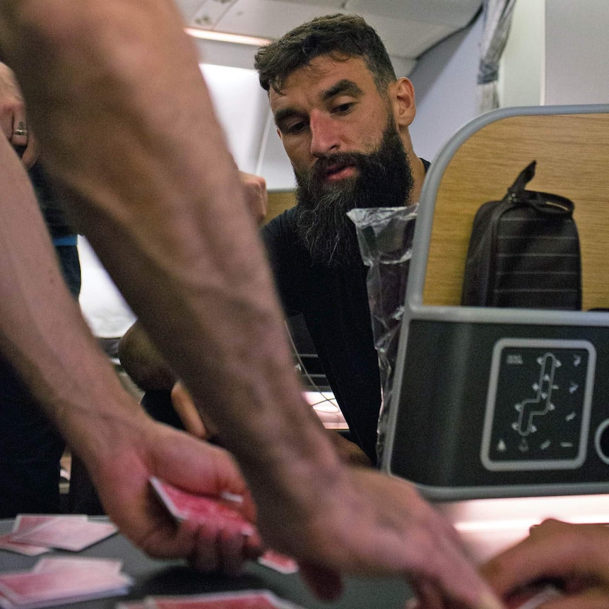 Mile Jedinak plays cards on Socceroos charter flight