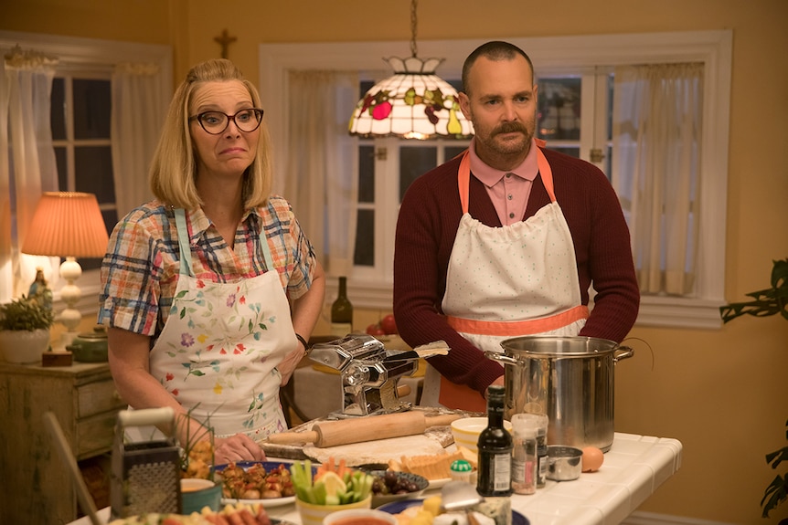 Colour film still of Lisa Kudrow and Will Forte cooking in kitchen in 2019 film Booksmart.