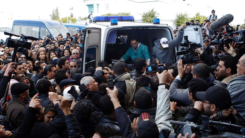 Body of Tunisian secular leader Chokri Belaid is carried into ambulance