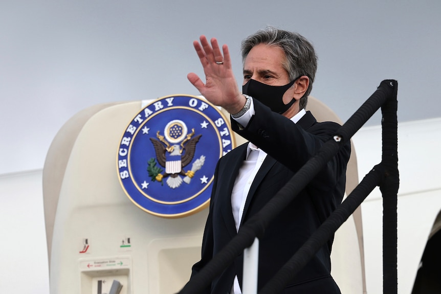 US Secretary of State Antony Blinken waves as he boards a plane