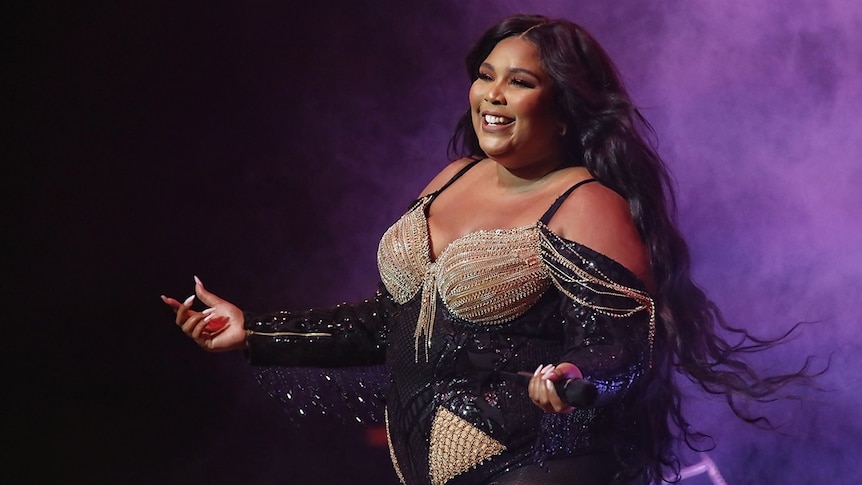 Pop singer Lizzo appears on stage.