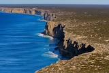 An aerial shot of cliffs next to the ocean.