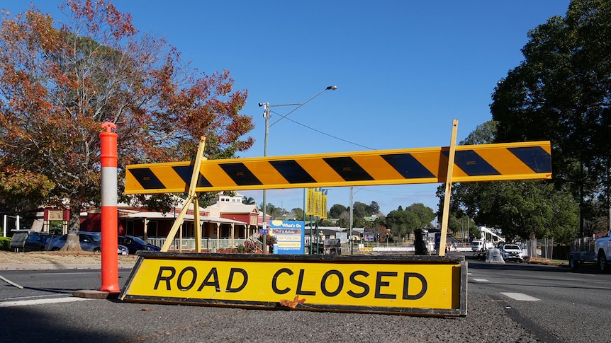 A yellow road closed sign stretches across a Toowoomba highway