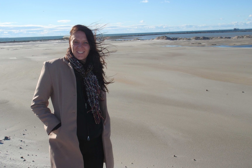 Rebecca Ryan standing on a beach.