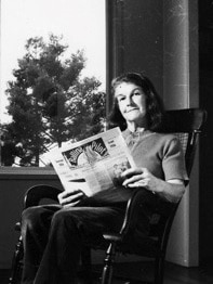 Black and white photo of Di Mercer with newspaper