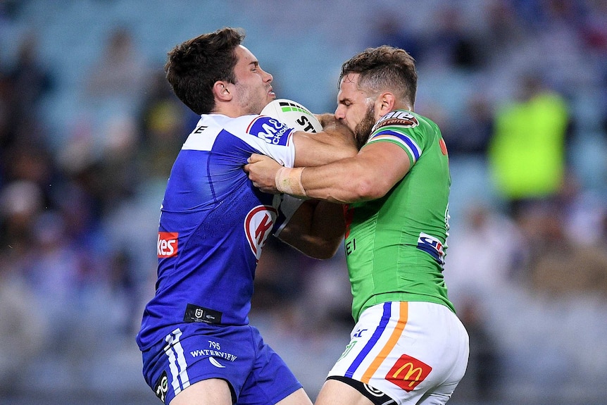 Nicholas Meaney holds the ball as he is tackled by Aiden Sezer.