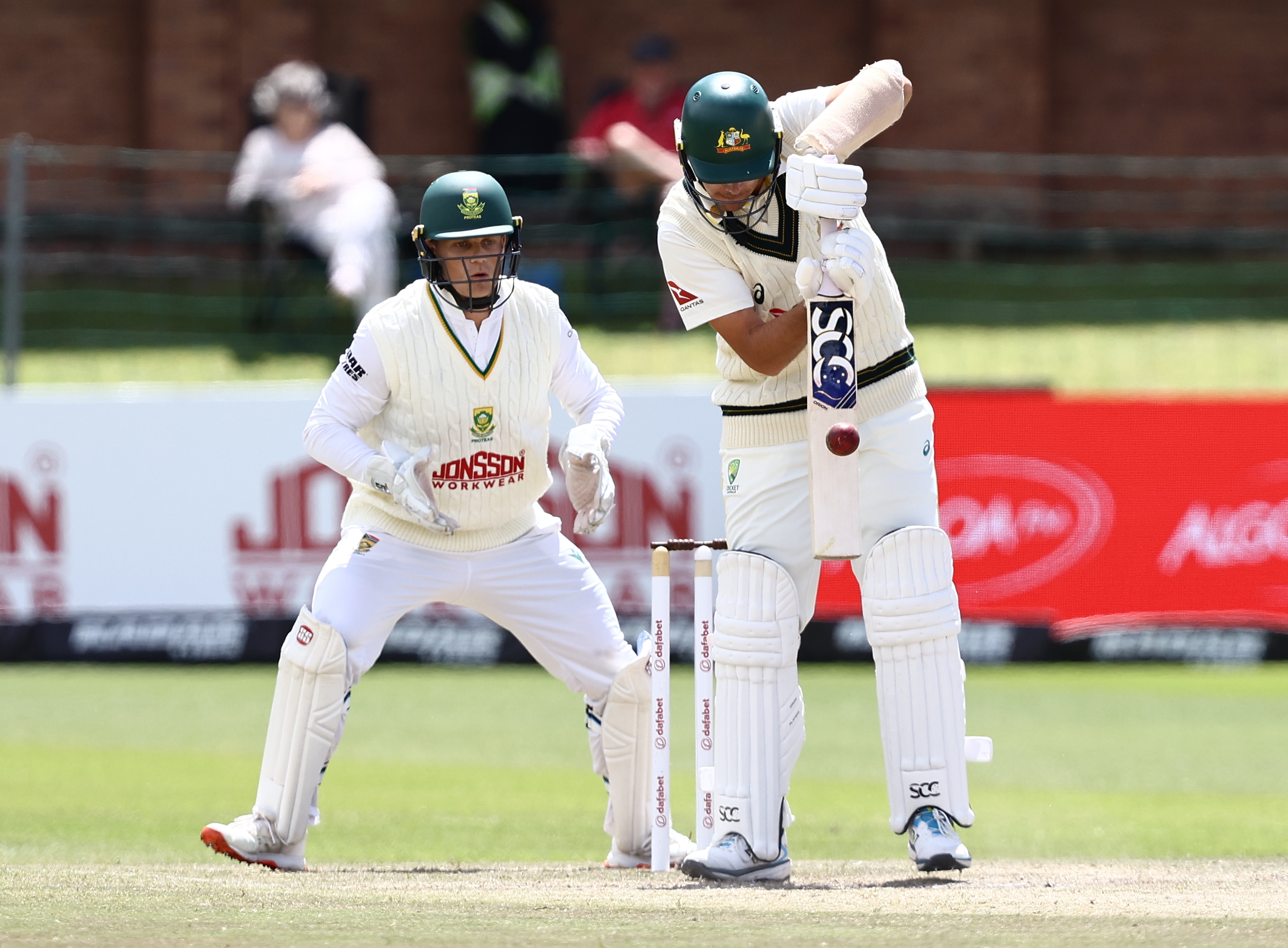 A cricket batter plays a shot with the middle of his bat