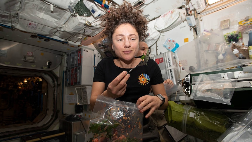 Astronaut eating a plant 